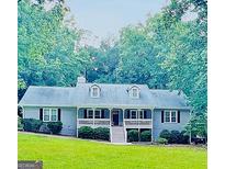 Charming single-Gathering home with a welcoming front porch and beautifully landscaped front yard at 155 Little Creek Dr, Sharpsburg, GA 30277