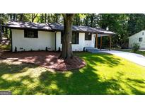 Charming renovated ranch with freshly landscaped lawn and covered entry at 5324 Joan Of Arc, Atlanta, GA 30349
