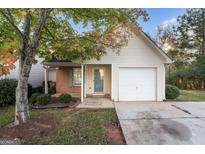 Inviting single-story home featuring a garage, landscaped front yard, and a charming entrance at 167 London Dr, Mcdonough, GA 30253