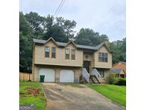 Charming two-story home with a well-maintained lawn and a two car garage at 2071 Scarbrough, Stone Mountain, GA 30088