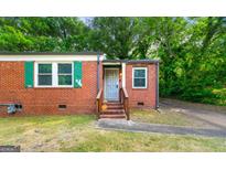 Charming brick home featuring well-kept landscaping and a cozy front entrance at 1737 Cahoon Sw St, Atlanta, GA 30310
