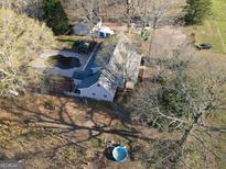 A lovely single Gathering home with in-ground pool set amongst mature trees in a large lot at 75 Price W Dr, Locust Grove, GA 30248