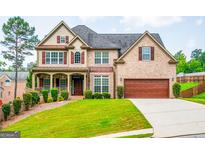Beautiful two-story brick home with a well-manicured lawn and an attached two-car garage at 4311 Hampton Mill Pkwy, Douglasville, GA 30135