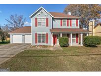 Charming two-story home with red shutters, light blue siding, and a well-manicured lawn at 453 Camp Hill Ln, Jonesboro, GA 30238