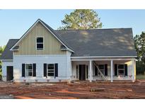 Charming new construction features a two-story design with a welcoming porch and classic black shutters at 78 Maddox Road, Mcdonough, GA 30252