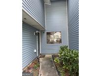 Charming front entrance showcasing a quaint walkway and vibrant green shrubbery at 8596 Creekwood Way, Jonesboro, GA 30238