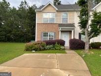 Charming two-story home with front lawn and driveway at 737 Outlook Way, Atlanta, GA 30349