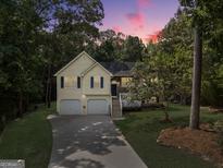Charming split-level home with a two-car garage and lush landscaping, perfect for families seeking comfort at 169 Knights Ct, Dallas, GA 30157