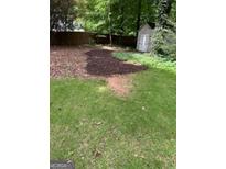 A backyard with an old shed, wood fence, and grassy area at 4887 Winterview Ln, Douglasville, GA 30135