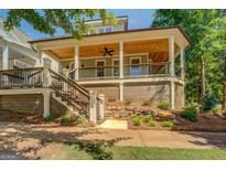 Inviting front porch with wood ceiling, fan, railing, and stairs at 5106 N Pratt St, Covington, GA 30014