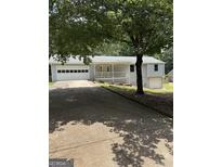 Charming home featuring an attached two car garage, basement garage, and inviting front porch at 276 Appalachee Church Rd, Auburn, GA 30011