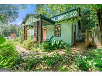 Charming home with colorful door, inviting front porch, and lush landscaping at 216 Leyden St, Decatur, GA 30030