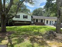 Split level home with lawn and shrubs at 268 Rountree Rd, Riverdale, GA 30274