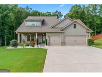 Charming home with a two-car garage, manicured lawn, and inviting front porch at 132 Whitworth Dr # 15, Locust Grove, GA 30248