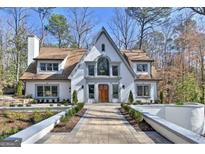 Stunning two-story home featuring manicured landscaping, symmetrical lines, a symmetrical roof, and a walkway to the front door at 4203 Harrogate Nw Dr, Atlanta, GA 30327