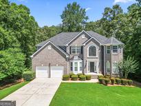 Beautiful two-story gray brick home with a well-manicured lawn and a two-car garage at 3688 Eagles Beek Cir, Lithonia, GA 30038