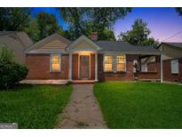Charming brick home featuring a well-manicured lawn and inviting front porch area at 1381 Sharon Sw St, Atlanta, GA 30314