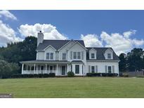 Charming two-story home boasts a welcoming porch and meticulously manicured front lawn at 794 Daileys Creek Dr, Mcdonough, GA 30253