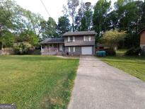 Charming two-story home with a well-maintained lawn and driveway at 55 Porter Cir, Hampton, GA 30228