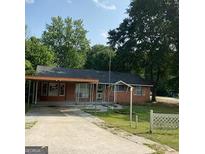 Charming single-story home with a covered parking area and front yard at 213 Whipporwill Way, Riverdale, GA 30274