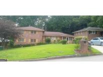 Charming two-story brick home featuring a well-maintained lawn and mature trees in a quiet neighborhood at 2342 Columbia Woods Ct, Decatur, GA 30032