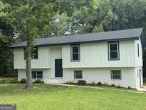 Charming two-story home with a white painted brick foundation and tidy landscaped front yard at 1608 Bogota Way, Jonesboro, GA 30236