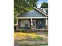 Charming home featuring a covered porch, stone accents, and a manicured lawn at 75 Orchard Dr, Covington, GA 30014