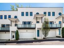 Contemporary townhome exterior boasting private balconies and garage parking at 1337 Grey Fox Ct # 7, Atlanta, GA 30306