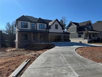 Two-story home with a large driveway and neutral color scheme at 2255 Buford Dam Rd, Buford, GA 30518