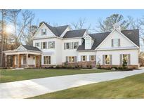 Stunning two-story home boasts white siding, gray shutters, and a charming covered porch with wooden pillars at 76 Telfair Ct, Acworth, GA 30101