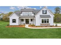 Beautiful two-story home with covered entrance and manicured lawn at 170 Ewing Way, Dacula, GA 30019