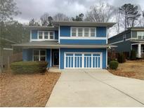 Charming two-story home with blue siding, white trim, and well-manicured front yard at 2331 Bouldercliff Se Way, Atlanta, GA 30316