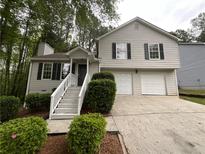 Charming two-story home with a well-maintained front yard and two-car garage at 5723 Antelope Trl, Atlanta, GA 30349