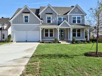 Two-story home with gray siding, white trim, and a covered front porch at 330 Cavin Dr, Roswell, GA 30076