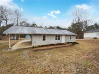 Charming single-story home featuring a carport and freshly landscaped front yard at 118 Mann Blvd, Stockbridge, GA 30281