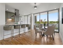 Bright kitchen and dining area with stainless steel appliances and breakfast bar seating offering natural light at 2575 Peachtree Ne Rd # 14H, Atlanta, GA 30305