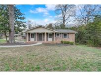 Charming brick ranch-style home featuring a well-maintained lawn and inviting front entrance at 3159 Nursery Se Rd, Smyrna, GA 30082
