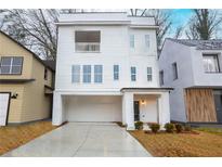 New construction with white siding, a balcony, and covered parking at 522 Pierce Nw Ave, Atlanta, GA 30318