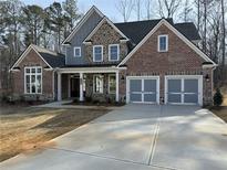 Stunning new construction home with a blend of brick, stone, and siding, plus a three-car garage at 1114 Low Water Crossing, Acworth, GA 30101