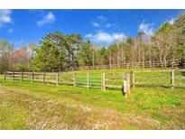 Serene pasture with wooden fence and gate, ready for horses at 450 Pat Rich Dr, Canton, GA 30115