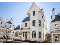 White two-story house with a gray roof and a wrap-around porch at 11530 Serenbe Ln, Chattahoochee Hills, GA 30268