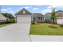 Charming one-story home featuring gray siding, manicured lawn, and a two-car garage at 128 Laurel Farms Ln, Dallas, GA 30157