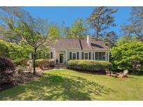 Charming traditional home featuring a well-manicured lawn, lush landscaping, and a cozy screened-in porch at 111 Mount Vernon Dr, Decatur, GA 30030
