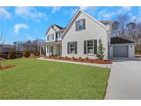 Charming two-story home with a well-manicured lawn and classic black shutters at 6680 Benchwood Path, Cumming, GA 30028