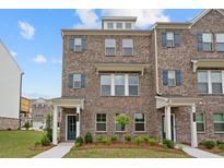 Charming two-story brick townhome with blue shutters and a well-manicured lawn at 1582 Halbrook Sw Pl, Marietta, GA 30008