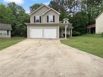 Charming two-story home with a two-car garage and a well-maintained front yard at 3542 Broad Oak Ct, Decatur, GA 30034