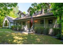 Charming home with a covered front porch, dormer windows, and manicured landscaping at 465 Se Willowbrook Se Dr, Smyrna, GA 30082