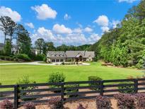Luxury home with expansive lawn, three-car garage, and private setting at 5759 Austin Garner Rd, Sugar Hill, GA 30518