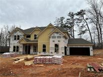 Two story new home with brick and siding exterior, three car garage and nice landscaping at 4125 Sierra Vista Cir, Cumming, GA 30040