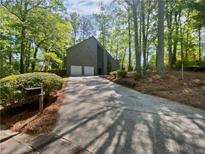 Charming two-story home with a two-car garage nestled among mature trees, offering a serene setting at 3213 Cedar Bluff Ne Dr, Marietta, GA 30062